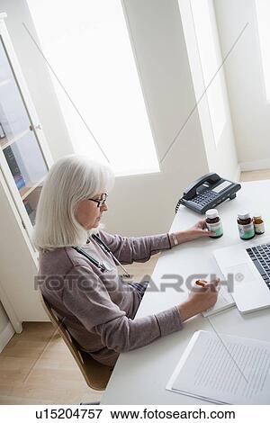 Stock Photo - Portrait of senior female doctor. Fotosearch