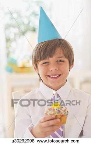 Portrait of smiling boy (10-11 years) in party hat View Large Photo Image Stock Photo - Portrait of smiling boy (10-11 years) in party hat. Fotosearch