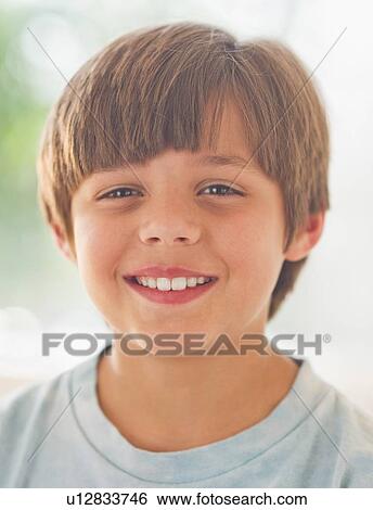 Stock Photograph - Portrait of smiling boy (10-11 years) . Fotosearch