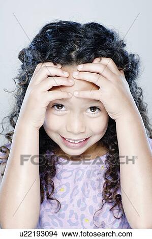 Picture - Portrait of smiling girl (8-9), studio shot. Fotosearch