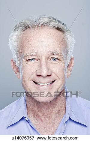 Stock Photo - Portrait of smiling senior man, studio shot. Fotosearch