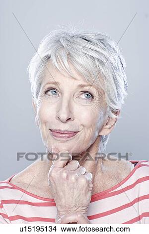 Picture - Portrait of smiling senior woman, studio shot. Fotosearch