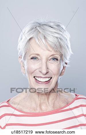 Portrait of smiling senior woman, studio shot View Large Photo Image Stock Photo - Portrait of smiling senior woman, studio shot. Fotosearch