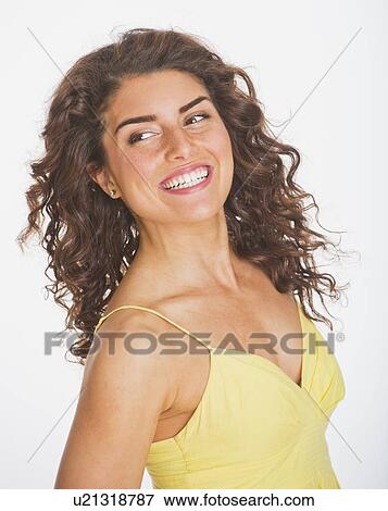 Stock Photo - Portrait of smiling woman, studio shot. Fotosearch
