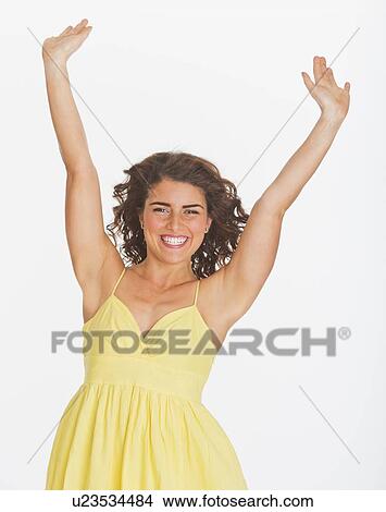 Portrait of smiling woman with arms up, studio shot View Large Photo Image Picture - Portrait of smiling woman with arms up, studio shot. Fotosearch