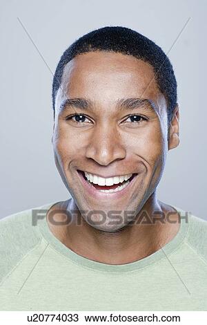 Portrait of smiling young man, studio shot View Large Photo Image Stock Image - Portrait of smiling young man, studio shot. Fotosearch