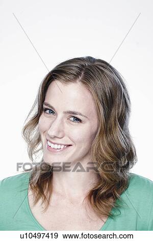 Stock Photo - Portrait of smiling young woman, studio shot. Fotosearch