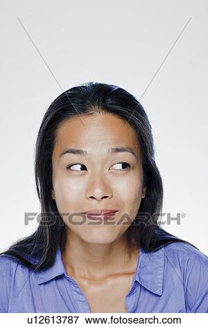 Stock Photo - Portrait of smiling young woman, studio shot. Fotosearch