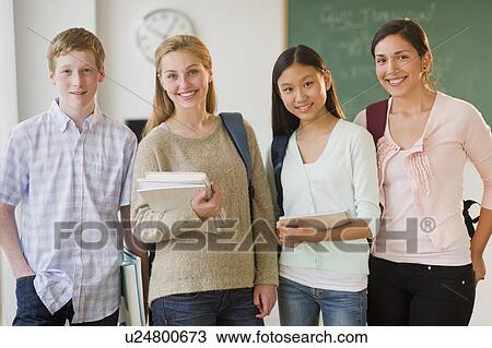 Stock Image - Portrait of students (14-19) in classroom. Fotosearch