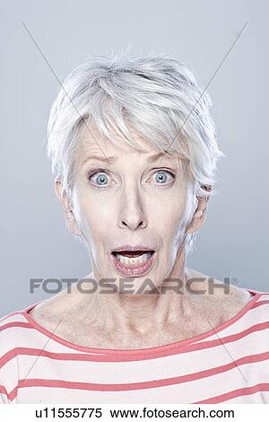 Stock Photography - Portrait of surprised senior woman, studio shot. Fotosearch