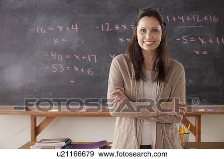 Portrait of teacher with blackboard in background View Large Photo Image Stock Photo - Portrait of teacher with blackboard in background. Fotosearch