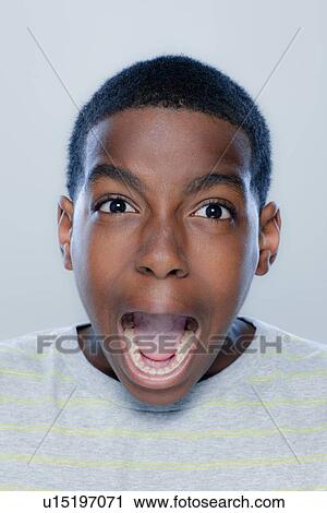 Portrait of teenage boy (14-15) screaming, studio shot View Large Photo Image Stock Image - Portrait of teenage boy (14-15) screaming, studio shot. Fotosearch