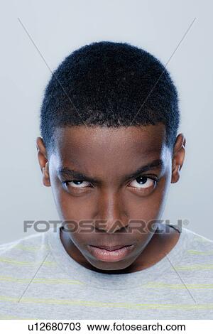 Stock Image - Portrait of teenage boy (14-15), studio shot. Fotosearch