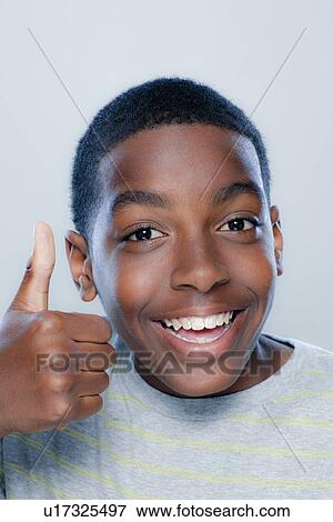 Stock Photo - Portrait of teenage boy (14-15), studio shot. Fotosearch