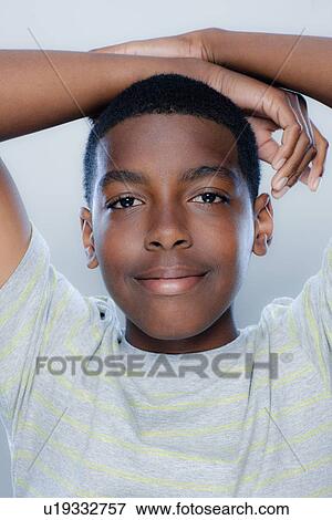 Stock Photo - Portrait of teenage boy (14-15), studio shot. Fotosearch