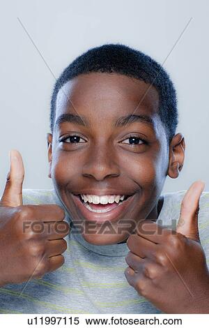Stock Photography - Portrait of teenage boy (14-15), studio shot. Fotosearch