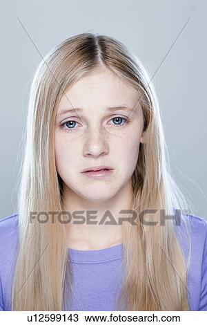 Stock Image - Portrait of teenage girl (14-15), studio shot. Fotosearch