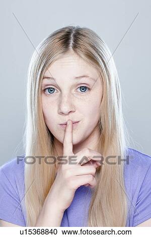 Stock Image - Portrait of teenage girl (14-15), studio shot. Fotosearch
