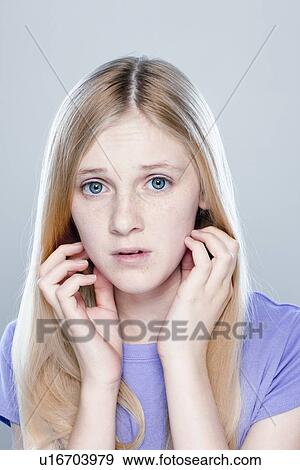 Stock Photo - Portrait of teenage girl (14-15), studio shot. Fotosearch
