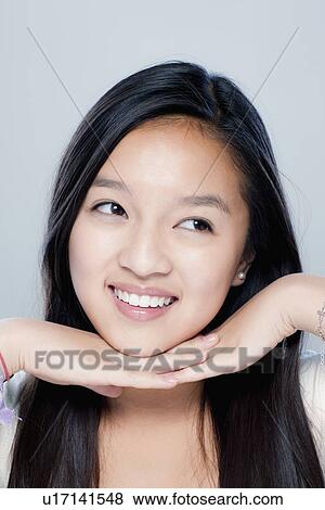 Stock Photo - Portrait of teenage girl (14-15), studio shot. Fotosearch