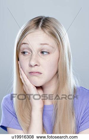 Stock Photo - Portrait of teenage girl (14-15), studio shot. Fotosearch