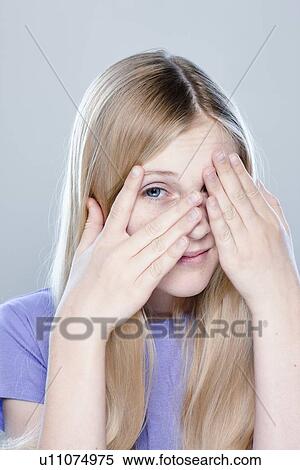 Stock Photography - Portrait of teenage girl (14-15), studio shot. Fotosearch