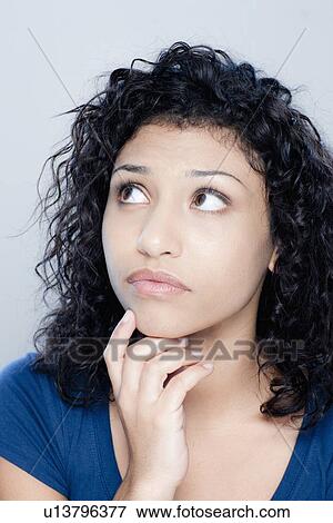 Stock Photo - Portrait of teenage girl (16-17), studio shot. Fotosearch