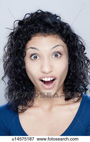 Stock Photo - Portrait of teenage girl (16-17), studio shot. Fotosearch