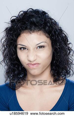 Stock Photo - Portrait of teenage girl (16-17), studio shot. Fotosearch