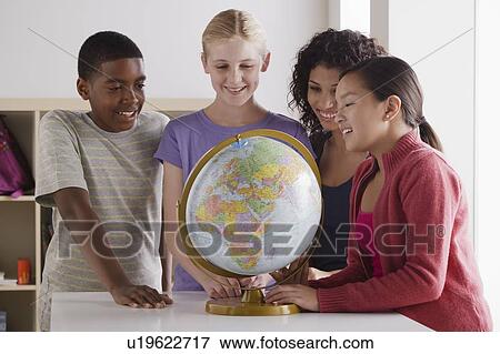 Portrait of teenage students (14-15, 16-17) with globe View Large Photo Image Stock Photo - Portrait of teenage students (14-15, 16-17) with globe. Fotosearch