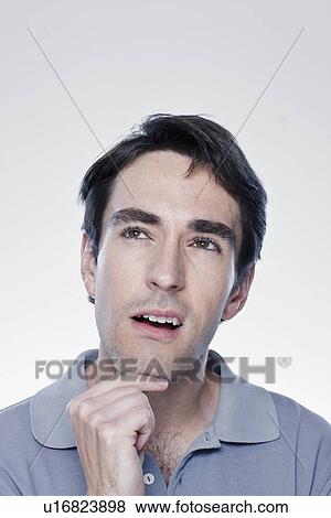 Stock Photo - Portrait of thoughtful man, studio shot. Fotosearch