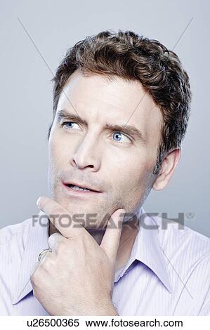 Portrait of thoughtful mid adult man, studio shot View Large Photo Image Stock Photography - Portrait of thoughtful mid adult man, studio shot. Fotosearch