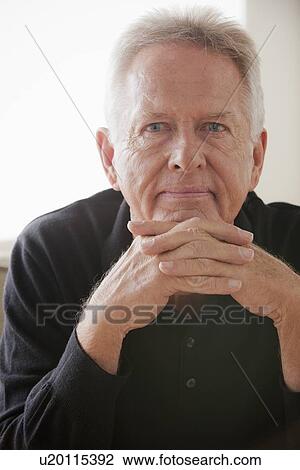 Stock Image - Portrait of thoughtful senior man. Fotosearch