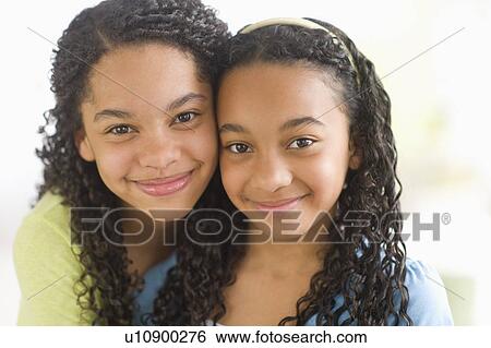 Stock Photograph - Portrait of two sisters (10-13). Fotosearch