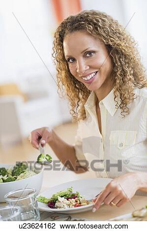 Portrait of woman eating dinner View Large Photo Image Stock Image - Portrait of woman eating dinner. Fotosearch