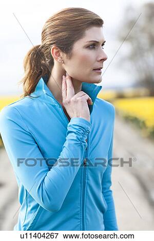 Stock Photo - Portrait of woman in blue tracksuit. Fotosearch