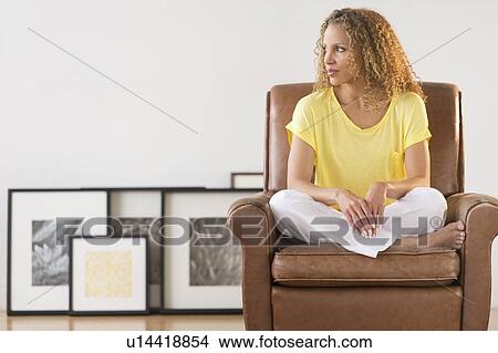 Picture - Portrait of woman sitting in armchair. Fotosearch