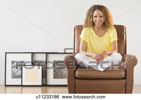 Portrait of woman sitting in armchair View Large Photo Image Stock Photograph - Portrait of woman sitting in armchair. Fotosearch