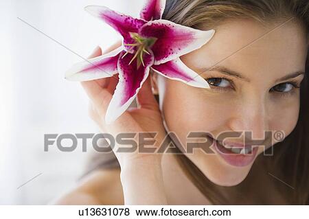 Portrait of woman with tropical flower in hair View Large Photo Image Stock Photo - Portrait of woman with tropical flower in hair. Fotosearch