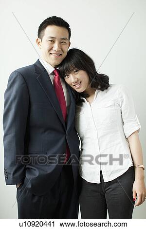 Portrait of young couple, studio shot View Large Photo Image Stock Image - Portrait of young couple, studio shot. Fotosearch