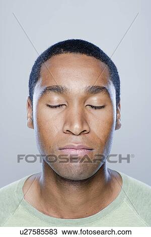 Portrait of young man with eyes closed, studio shot View Large Photo Image Stock Image - Portrait of young man with eyes closed, studio shot. Fotosearch