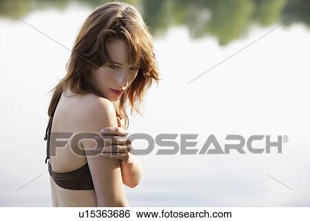 Portrait of young woman against lake View Large Photo Image Stock Photograph - Portrait of young woman against lake. Fotosearch