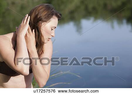 Portrait of young woman against lake View Large Photo Image Stock Photograph - Portrait of young woman against lake. Fotosearch