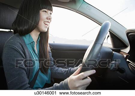 Portrait of young woman in car View Large Photo Image Stock Image - Portrait of young woman in car. Fotosearch