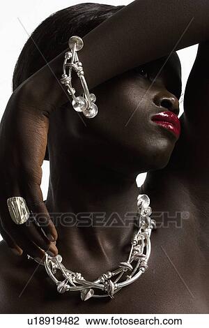 Stock Image - Portrait of young woman in necklace. Fotosearch
