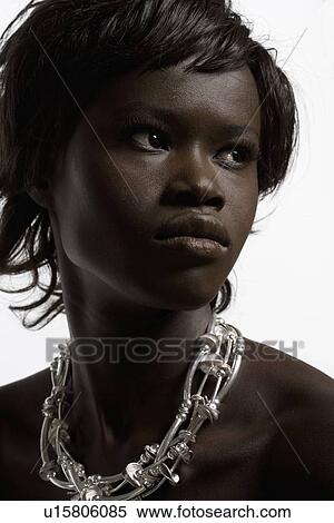 Stock Photography - Portrait of young woman in necklace. Fotosearch