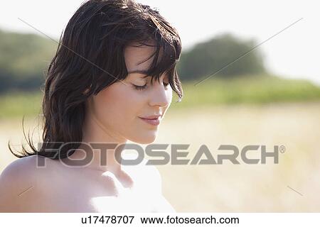 Portrait of young woman in strong sunlight View Large Photo Image Stock Photo - Portrait of young woman in strong sunlight. Fotosearch