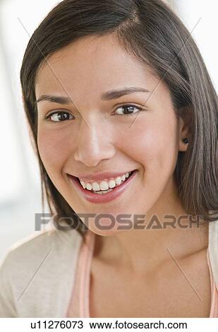 Stock Image - Portrait of young woman smiling. Fotosearch