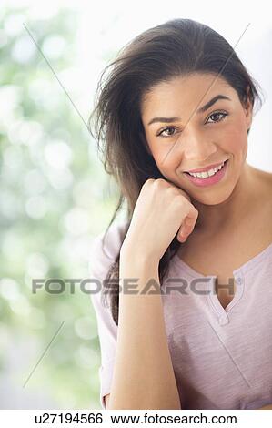 Stock Photograph - Portrait of young woman smiling. Fotosearch
