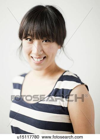 Portrait of young woman, studio shot View Large Photo Image Stock Image - Portrait of young woman, studio shot. Fotosearch